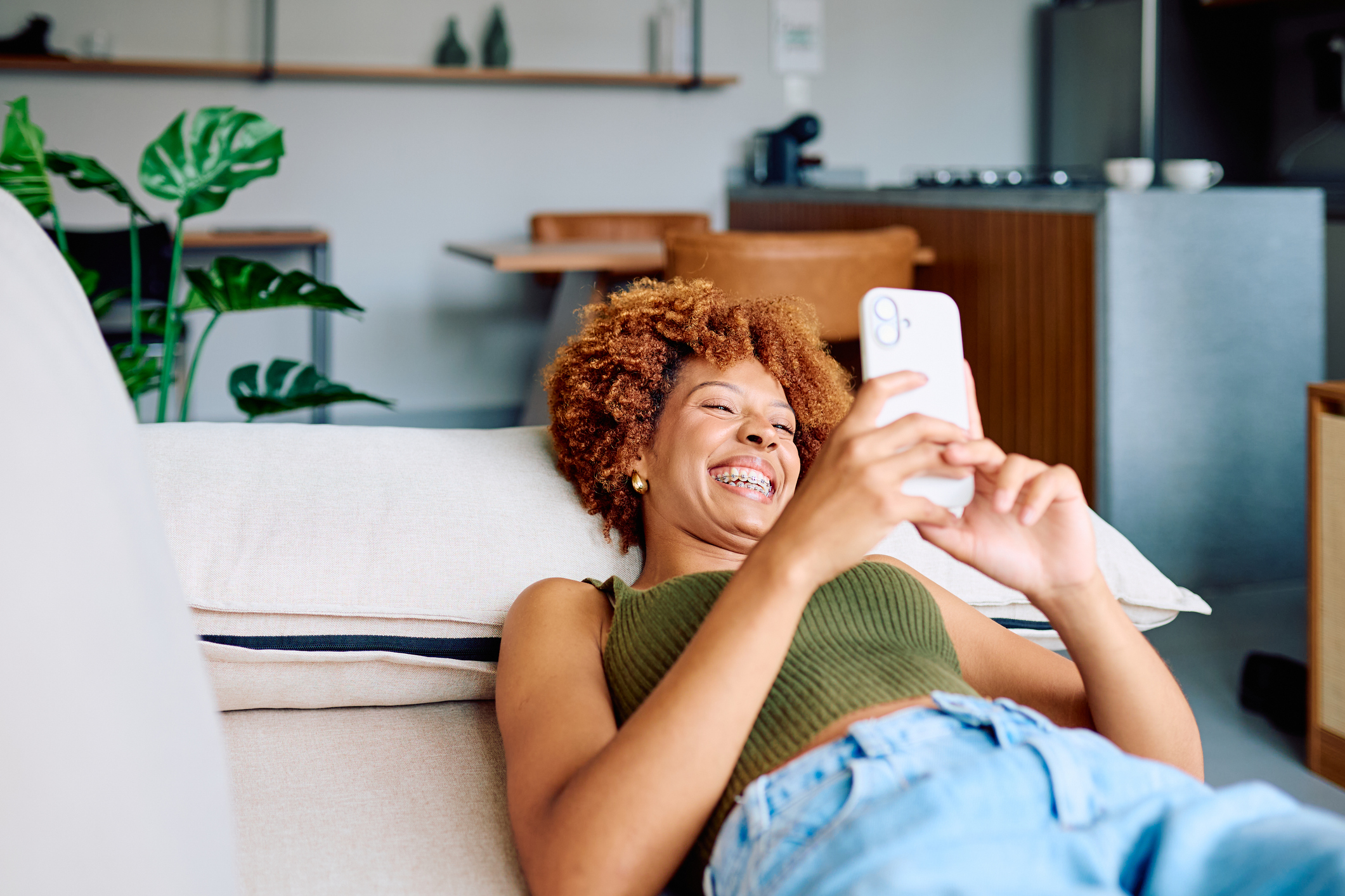 Young woman laughing and relaxing at home with braces